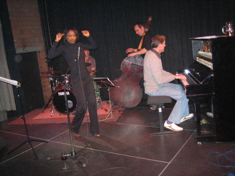 Willetta Carson performs Summer Samba, latin jazz and swing at E-Werk, Erlangen. Onstage camera shot with musicians at piano, bass and drums.